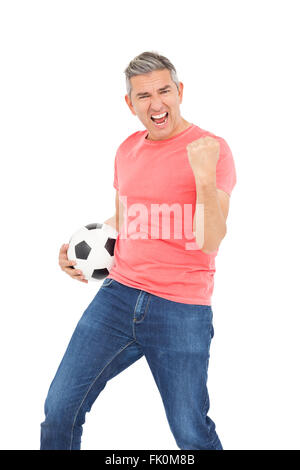 Happy guy holding a soccer ball Stock Photo - Alamy