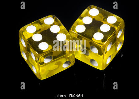 Yellow dice on black background Stock Photo