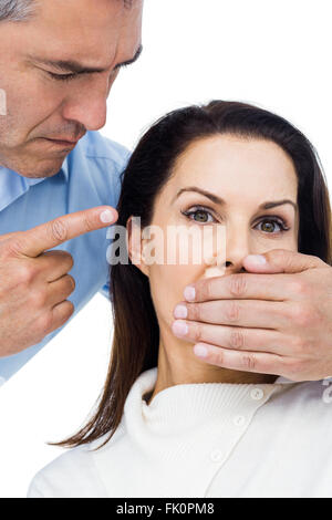 Man covering wifes mouth Stock Photo - Alamy