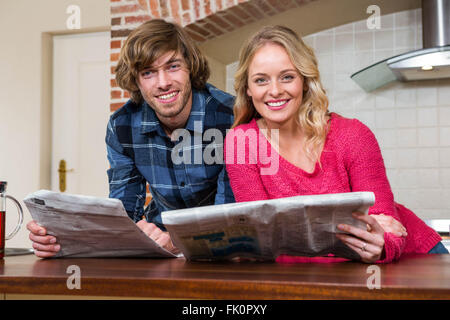 Cute couple reading the newspaper Stock Photo