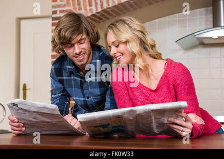 Cute couple reading the newspaper Stock Photo