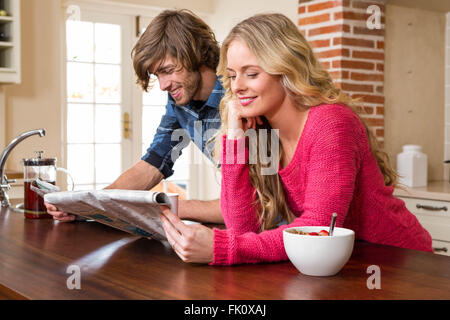 Cute couple reading the newspaper Stock Photo