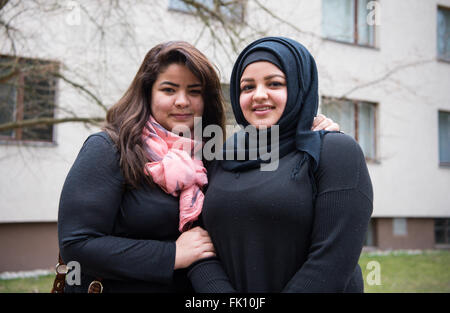 Berlin, Germany. 3rd Mar, 2016. Zahraa Elhasoon (l) and her sister Samah Elhasoon, refugees from Iraq, standing in front of a residential home for fled women and families in Berlin, Germany, 3 March 2016. Photo: Bernd von Jutrczenka/dpa/Alamy Live News Stock Photo