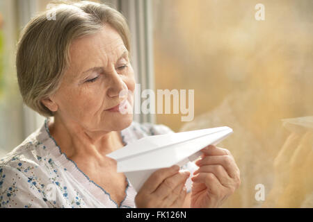woman with paper plane Stock Photo