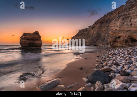 Sand and Pebble beach in Kos island of Greece during sunset. Shot taken from Cavo Paradiso in Kefalos region. Exotic destination Stock Photo