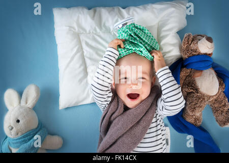 Ill boy lying in bed Stock Photo