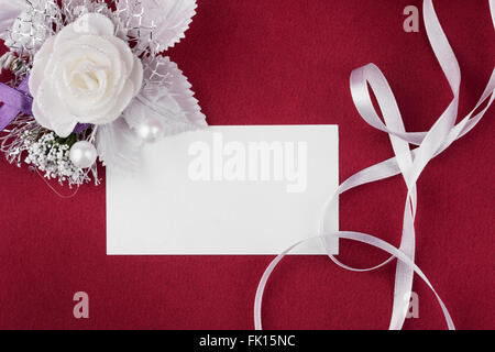 Background with  flower and empty tag for your text on red silk  background.  Square image. Stock Photo