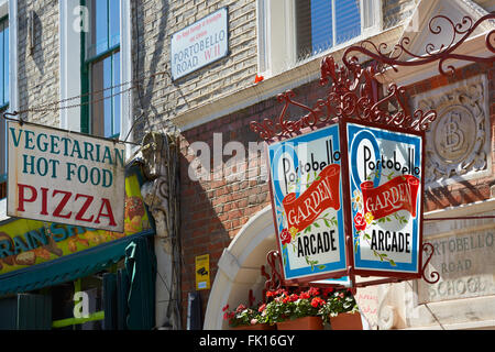 Portobello road street sign, old street lamp and restaurant sign in a sunny day in London Stock Photo