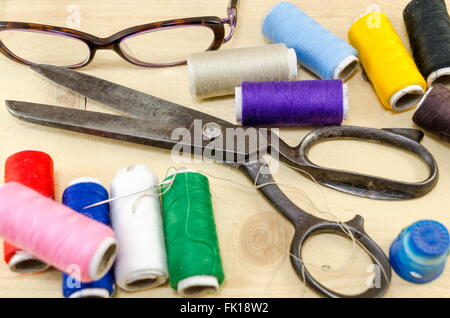 Sewing equipment chaos scattered on the table Stock Photo
