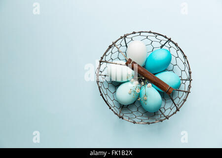 Ombre Easter eggs in a wire basket Stock Photo