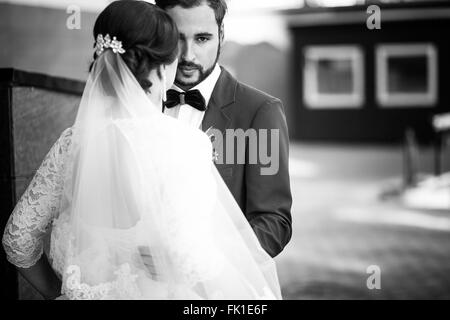 Bride and groom monochrome portrait. The man has a serious look, wedding retro classic. Stock Photo