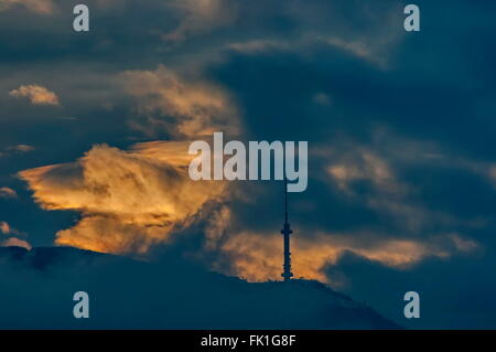 Vitosha mountain with TV tower over Sofia city at dusk stormy sunset, Bulgaria Stock Photo