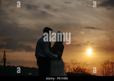 Silhouette of  wedding couple in field Stock Photo