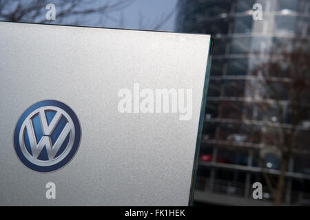 A VW logo seen on a sign in front of the Transparent Factory of German car manufacturer Volkswagen in Dresden, Germany, 03 March 2016. Photo: ARNO BURGI/dpa Stock Photo