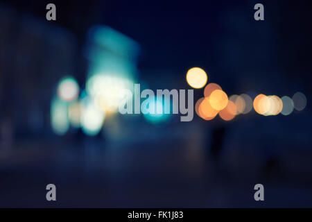 Artistic Style Defocused Urban abstract bokeh. City lights in the background with defocused lights for your design, vintage retro color toned colorized shot Stock Photo