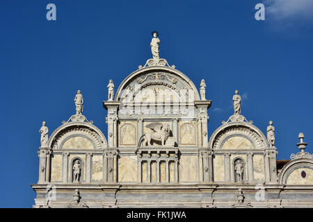 Upper part of Renaissance Scuola Grande di San Marco monumental facade in Venice, with Saint Mark winged lion, designed by artis Stock Photo