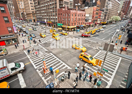 NEW YORK - MARCH 21: City streetlife in point of intersection of 7th Av. and 23th st. near the famous Chelsea Hotel on March 21, Stock Photo