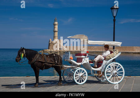 Horse and carriage waiting to pick up tourists at the historic Venetian harbour at Chania, Crete, Greece Stock Photo
