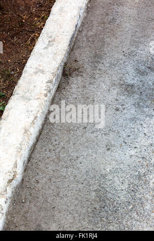 white curb and asphalt road Stock Photo