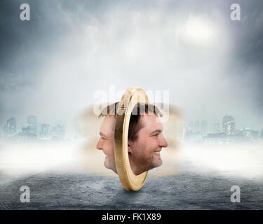 Male face on two sides of the coin Stock Photo