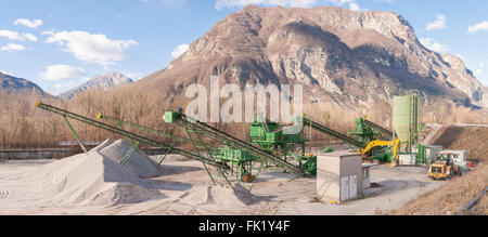 Gravel extraction plant.   Machinery and classification according gravel size distribution via conveyor belts. Stock Photo