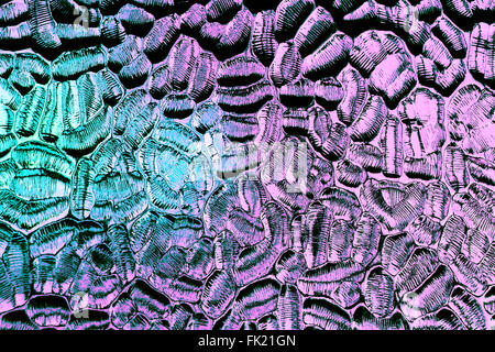 Coloured glass pattern in close up on window in green and blue Stock Photo