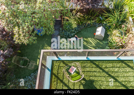 VENICE, CA – AUGUST 19: Glen Irani and son Marlo Irani relax on their artificial grass in Venice, California on August 19, 2005. Stock Photo