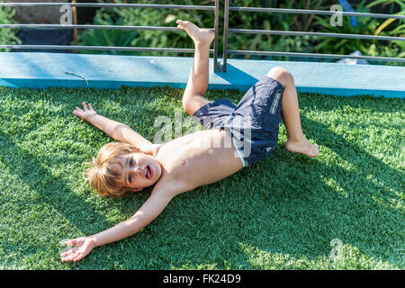 VENICE, CA – AUGUST 19: Glen Irani and son Marlo Irani relax on their artificial grass in Venice, California on August 19, 2005. Stock Photo