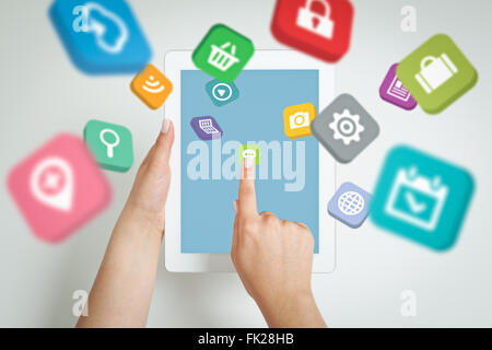 female hand touching screen and application icons fly Stock Photo