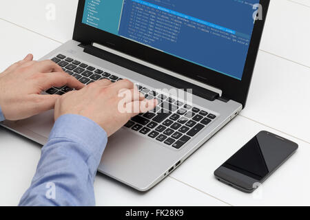 Developer working on source codes on laptop at office Stock Photo