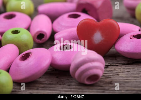 macro toy beads on a wooden surface Stock Photo
