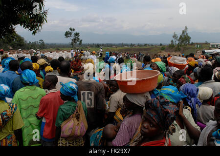 Internally displaced people wait for a food distribution carried out by UN World Food Programme WFP in North Kivu province DR Congo Africa Stock Photo