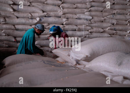 Employees of the World Food Programme WFP stack large sacks of basic foodstuffs at a logistics center in the city of Goma in North Kivu province DR Congo Africa Stock Photo