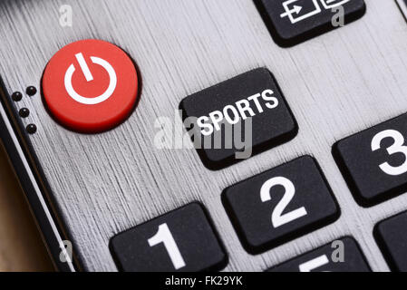 Close up detail of a Sport and on off button on a TV remote control Stock Photo