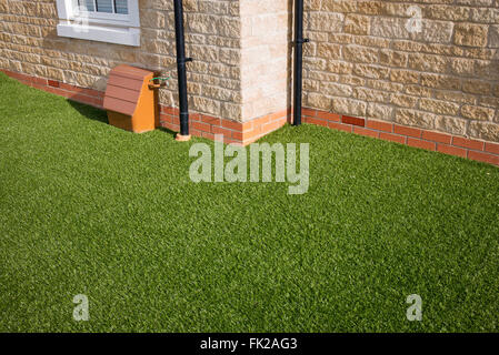 Artificial grass / astro turf on a new build housing estate. Bicester, Oxfordshire, England Stock Photo