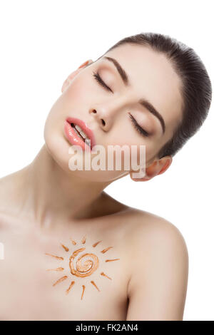 Girl with cream sun shape drawing on chest Stock Photo