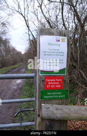 Warning car thieves sign on the entrance gate to a nature reserve, at Canada farm, near Meare, Somerset. March 2016 Stock Photo