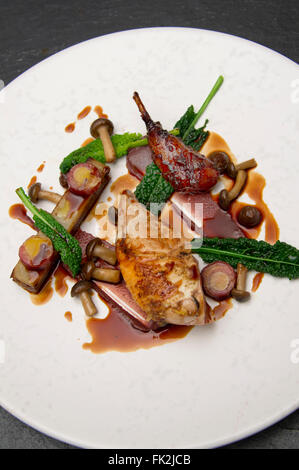 Roasted reg legged partridge,potato and fig terrine, choucroute of kohirabi and morteau sausage.a UK food foods cuisine Stock Photo