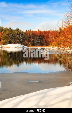 Lake Sisjon (Sisjön) partially covered in ice in the winter, Mölndal or Gothenburg (half of the lake belongs to each town), Sweden.  Model Release: No.  Property Release: No. Stock Photo