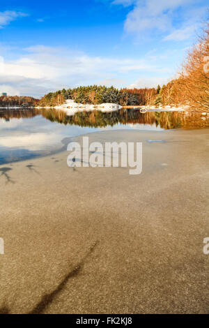 Lake Sisjon (Sisjön) partially covered in ice in the winter, Mölndal or Gothenburg (half of the lake belongs to each town), Sweden.  Model Release: No.  Property Release: No. Stock Photo