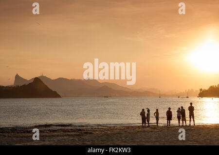 Fishermen pulling in their net on the beach in Niteroi, Rio de Janeiro Stock Photo