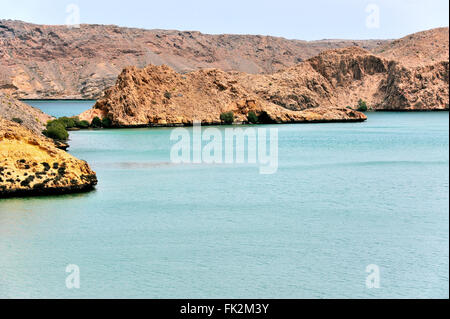 Bay with fascinating rocks, near Fins at the coastline in As Sifah invites to swim, near Muscat, Oman, near diving center Stock Photo
