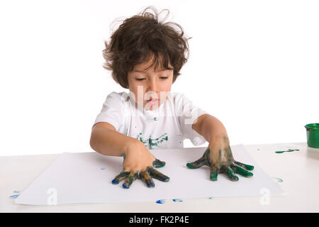 Little Boy Is Making A Finger- Painting on white background Stock Photo
