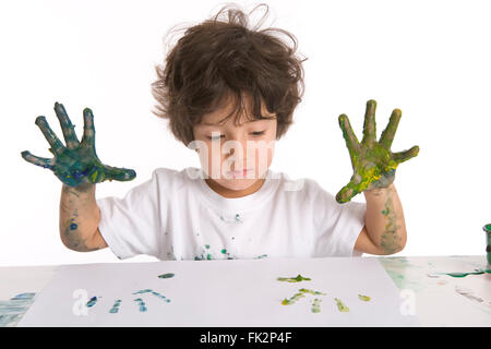 Little Boy Is Making A Finger- Painting on white background Stock Photo