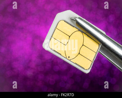 sim card on tweezers Stock Photo