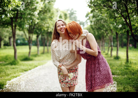 Two Young Pretty Girls Having Fun Outdoors in Summer Time. Freedom Youth Concept. Happy Women Laughing. Stock Photo