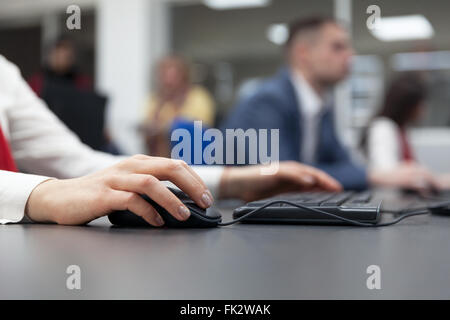 Close up of a woman using the computer at the workshop Stock Photo