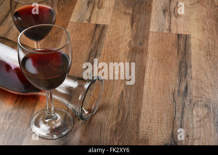 Top view of a carafe and two wine glasses on a wood table with copy space. Stock Photo