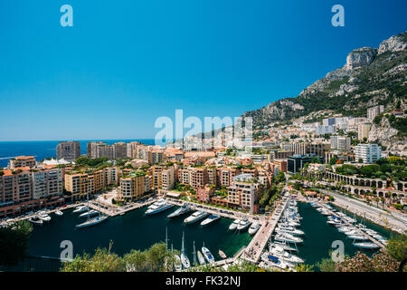 Yachts moored near city Pier, Jetty In Sunny Summer Day. Monaco, Monte Carlo architecture. Stock Photo