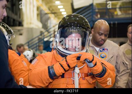 NASA astronaut Mark Kelly , STS-134 commander, dons a training version of his shuttle launch and entry suit in preparation for a training session in the Space Vehicle Mock-up Facility Johnson Space Center February 3, 2010 in Houston, Texas. Stock Photo